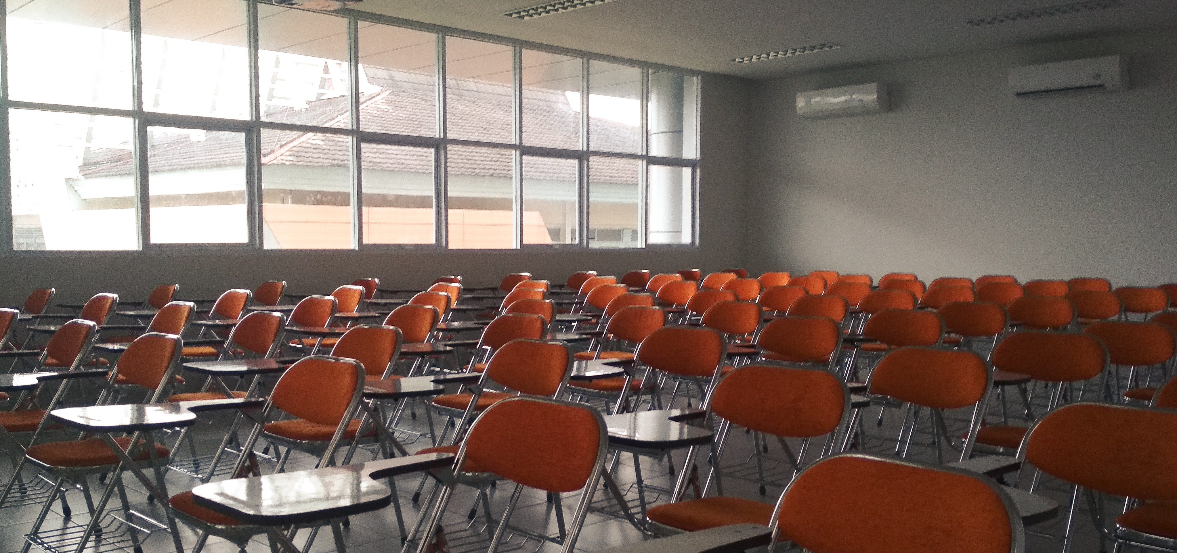 Empty classroom with orange chairs
