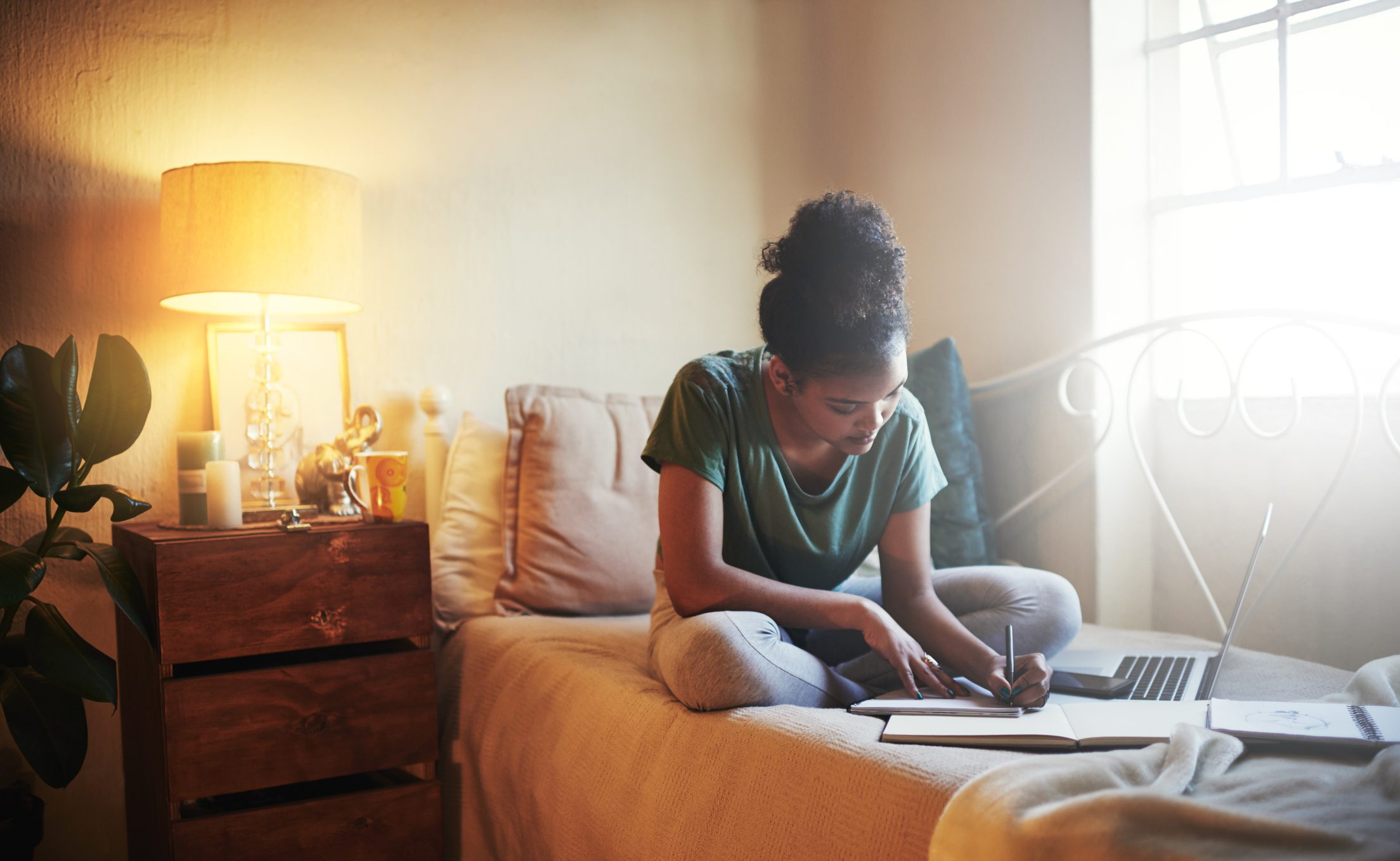 Student studying in bed