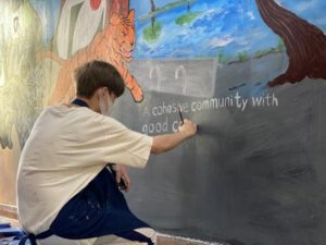 A student paints a mural