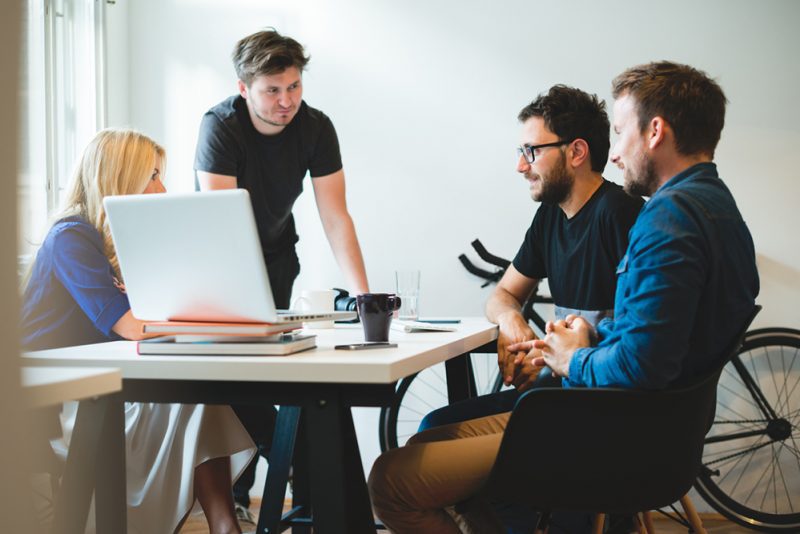 4 people having a meeting