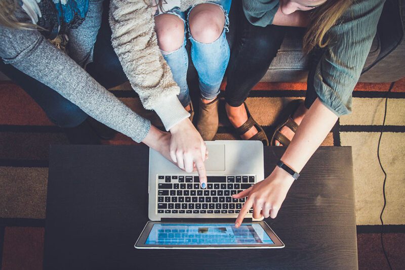 Students pointing to a laptop screen