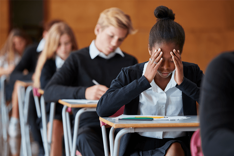 Student in an exam room looking stressed