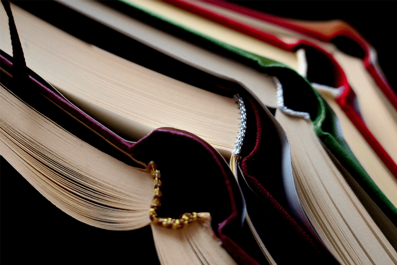 Stack of five open books