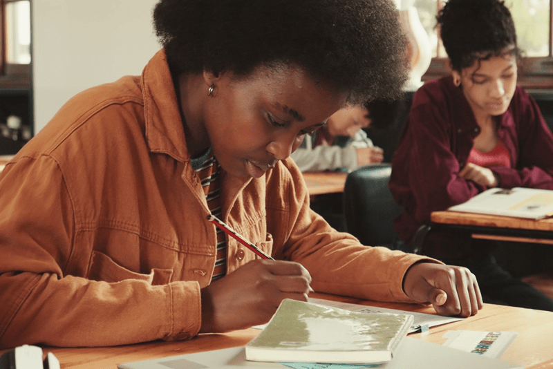 Student sitting at a desk completing a worksheet