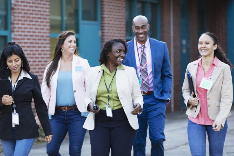Group of teachers walking together outside school